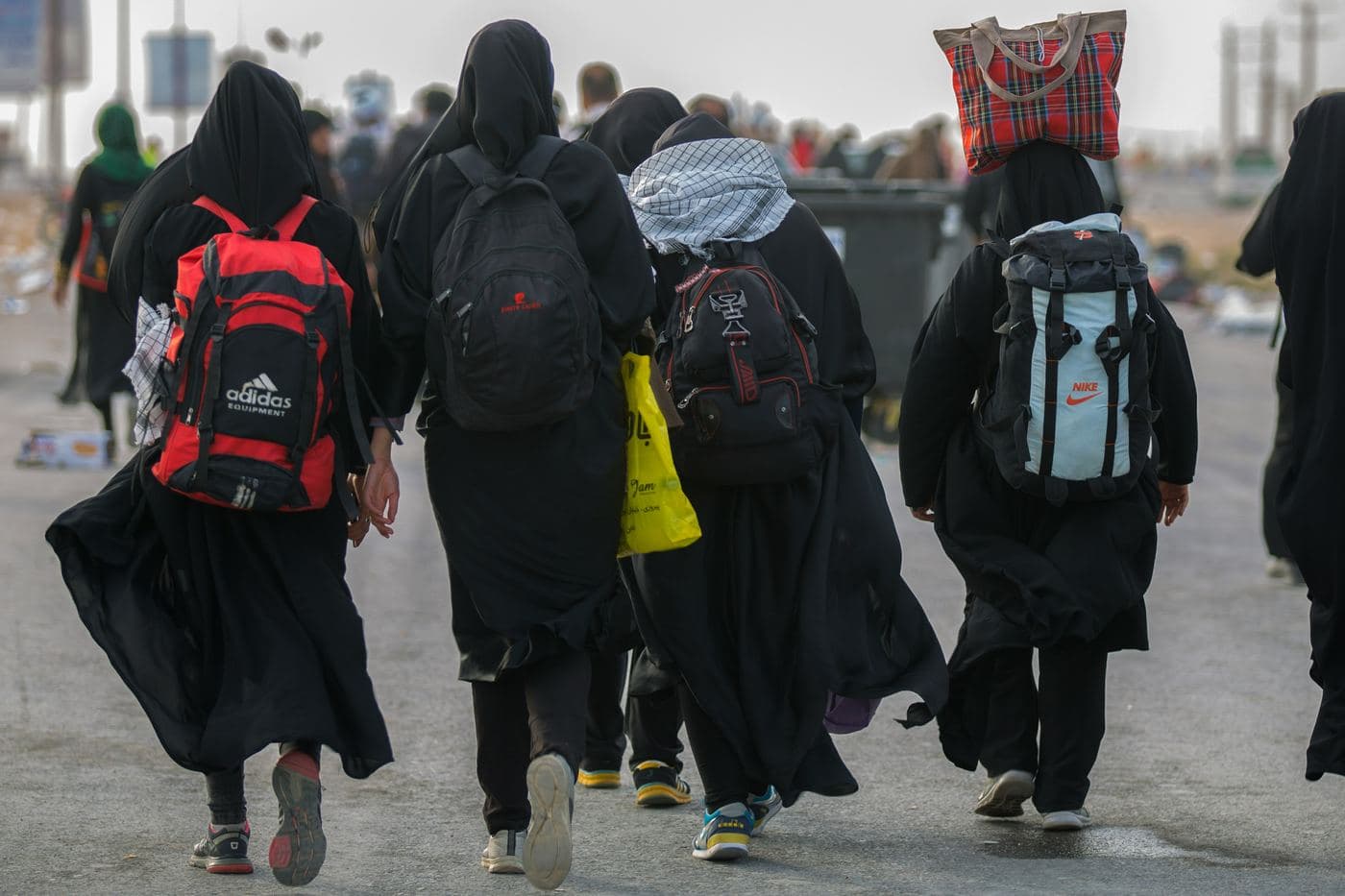 Travelers walking together, carrying their belongings