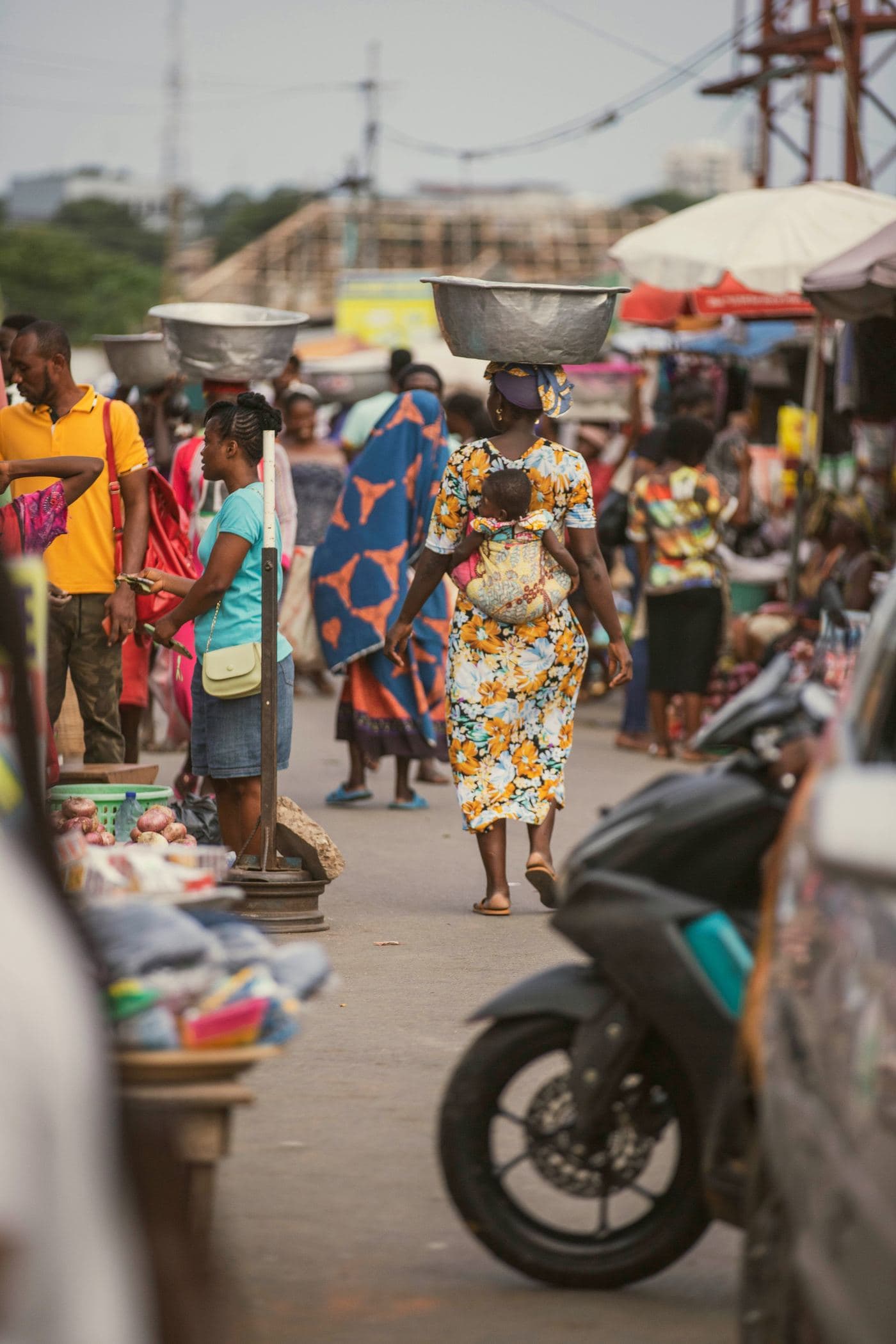 A woman carries goods to market in Ghana